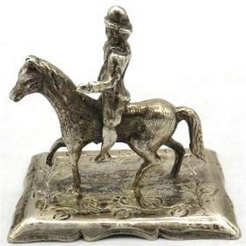 331 - A white metal figure of a man riding a horse, marks to base, possibly Dutch. Approx 2