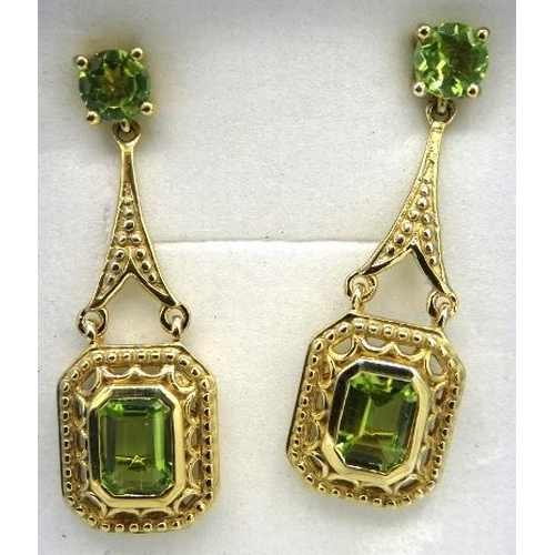 344 - Peridot earrings. 35mm drop. Faceted bezel set octagon & round cut stones of good colour & clarity. ... 