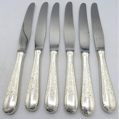 354 - A set of six dinner knives with embossed foliate & scroll design handles, marked Birks Sterling.
Con... 