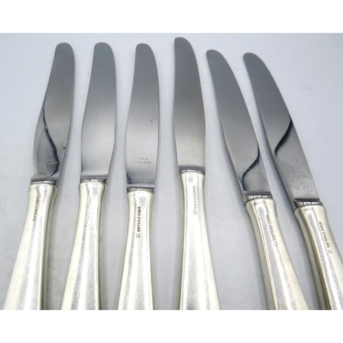 354 - A set of six dinner knives with embossed foliate & scroll design handles, marked Birks Sterling.
Con... 