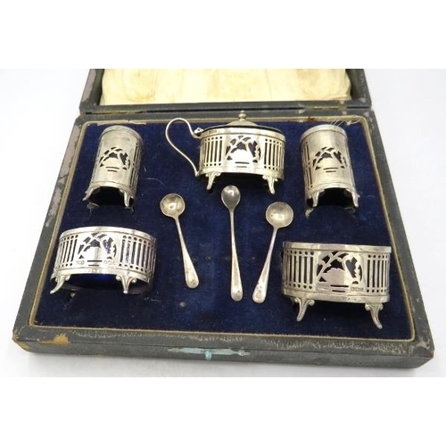 367 - A five piece silver condiment set with pierced & swan decoration with two silver salt spoons and a s... 