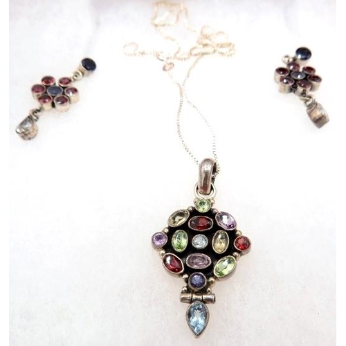 380 - A white metal pendant set with a group of semi-precious stones including garnets, amethyst & topaz i... 