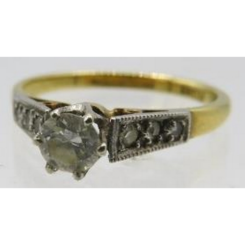 393 - An 18ct yellow gold platinum solitaire diamond ring with diamond graduated shoulders. Centre diamond... 