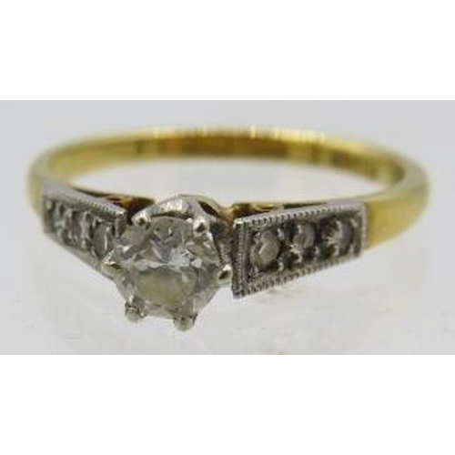 393 - An 18ct yellow gold platinum solitaire diamond ring with diamond graduated shoulders. Centre diamond... 