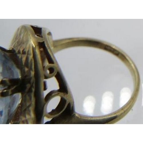 405 - A yellow metal pale blue topaz set ring. Topaz approx 12mm x 10mm, size H, marks worn. Approx weight... 