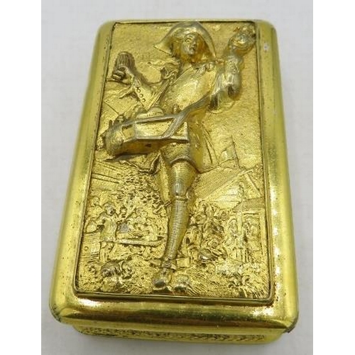 424 - A gilded metal table snuff box heavily embossed with a pedlar, indistinct marks at the top. Approx 4... 