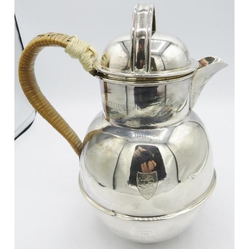 429 - A large silver Guernsey jug with wicker handle, London 1948, engraved shield. Approx 8