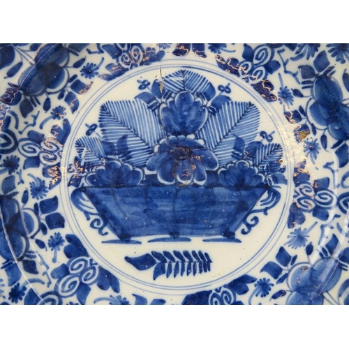 43 - A Dutch Delft blue and white charger, 18th century. Painted with a basket of flowers to the centre e... 