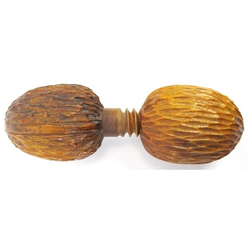 48 - A novelty treen nutcracker. The wood carved in the form of two oversized walnuts incorporated with a... 