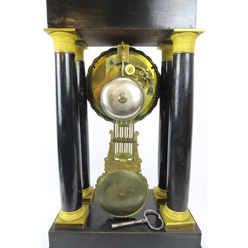 50 - A French ebonised and ormolu mounted Portico clock, 19th century. With four tapered columns, the dia... 