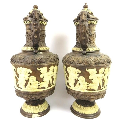 62 - A large pair of German relief moulded ewers and covers, 19th century. Profusely decorated in high re... 