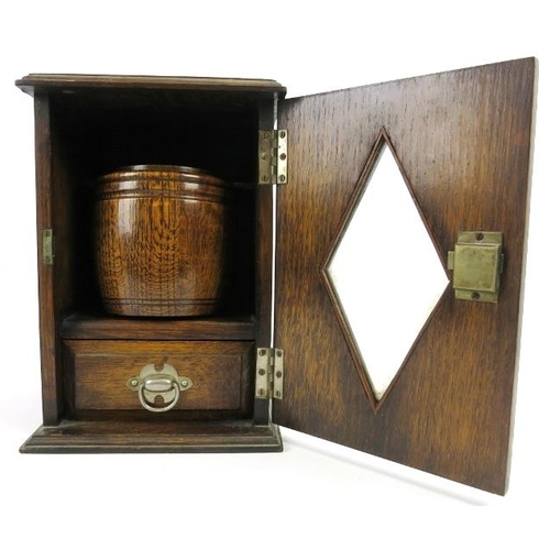 66 - An oak humidor, early/mid 20th century. The hinged door with lozenge glass front opens to reveal a h... 