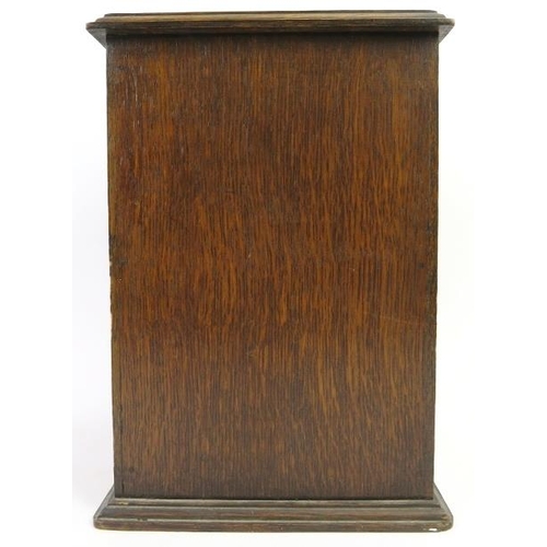 66 - An oak humidor, early/mid 20th century. The hinged door with lozenge glass front opens to reveal a h... 