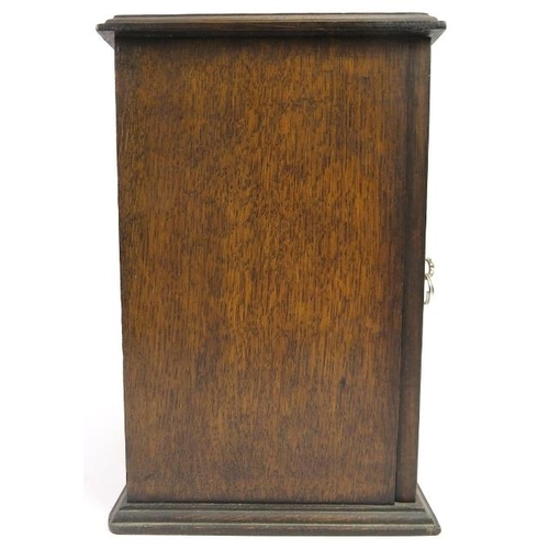 66 - An oak humidor, early/mid 20th century. The hinged door with lozenge glass front opens to reveal a h... 