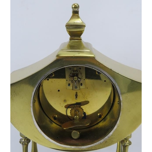 90 - A brass twin handled mantle clock, early 20th century. With Neoclassical elements. Key and pendulum ... 