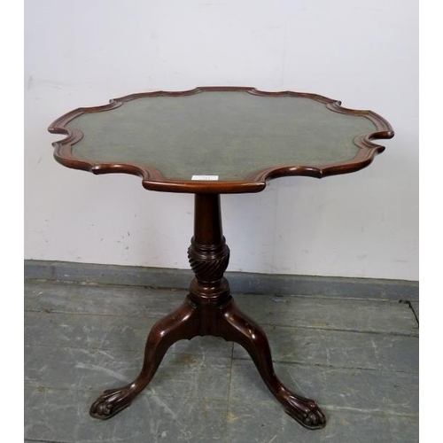 711 - A 19th century mahogany shaped-edge tilt-top table, on a tapering spiral carved column with splayed ... 