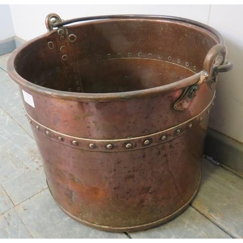 713 - A 19th century riveted and banded copper log bin, with steel handle. 
H35cm Diameter 40cm (approx).
... 