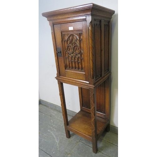 718 - A well carved vintage medium oak cabinet in the Gothic taste, featuring linen fold panelling and int... 