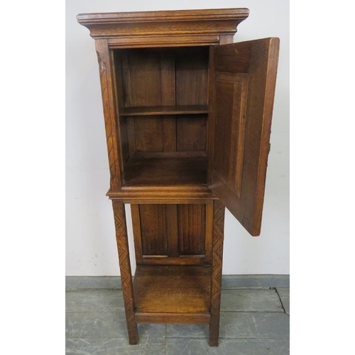 718 - A well carved vintage medium oak cabinet in the Gothic taste, featuring linen fold panelling and int... 