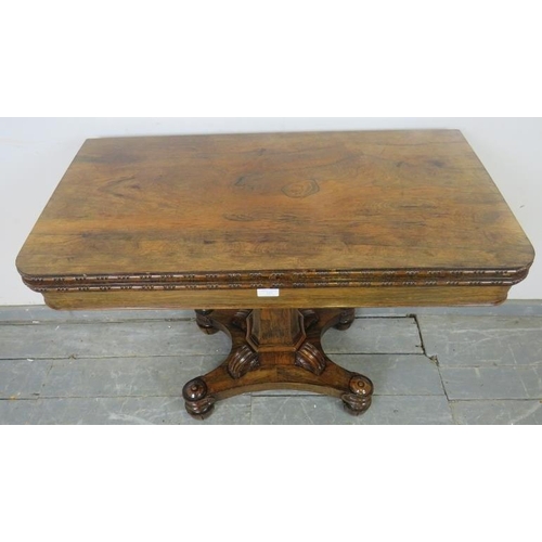 725 - A Victorian rosewood turnover card table with inset green baize, on a tapering octagonal column abov... 