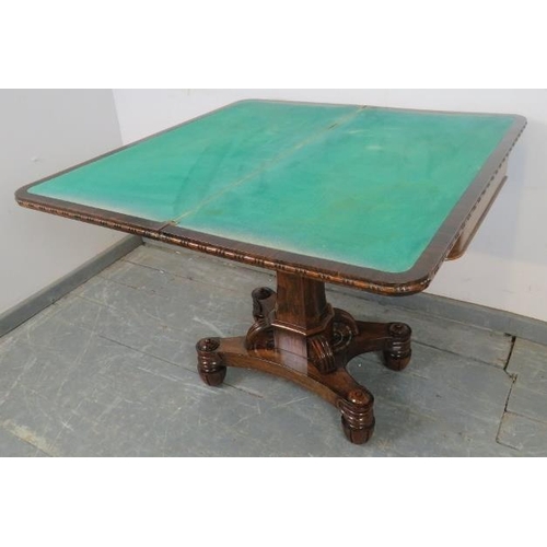 725 - A Victorian rosewood turnover card table with inset green baize, on a tapering octagonal column abov... 