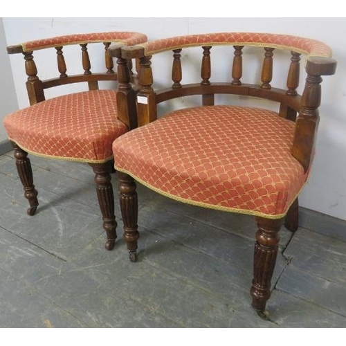 728 - A pair of 19th century oak tub chairs, upholstered in red and gold patterned material, on fluted tap... 