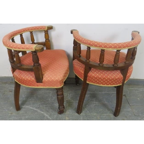 728 - A pair of 19th century oak tub chairs, upholstered in red and gold patterned material, on fluted tap... 