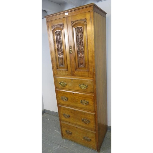 729 - An Edwardian satin walnut linen press of small and narrow proportions, the panelled doors, relief ca... 