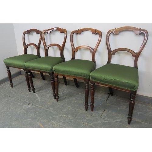 730 - A set of four Victorian rosewood balloon back dining chairs with green upholstery, on tapering reede... 