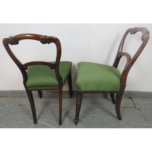 730 - A set of four Victorian rosewood balloon back dining chairs with green upholstery, on tapering reede... 