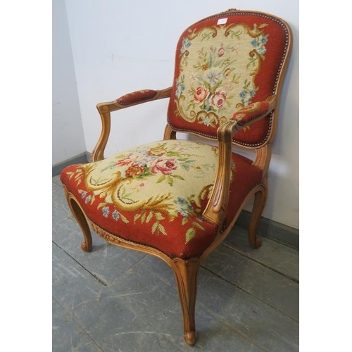 731 - A vintage French oak open-sided armchair in the Louis XV taste, with acanthus carved arms, upholster... 