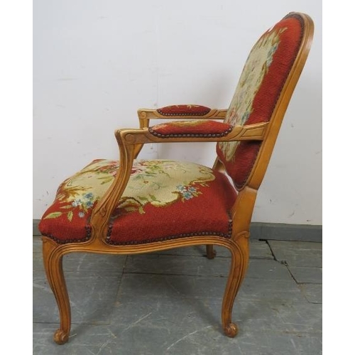 731 - A vintage French oak open-sided armchair in the Louis XV taste, with acanthus carved arms, upholster... 