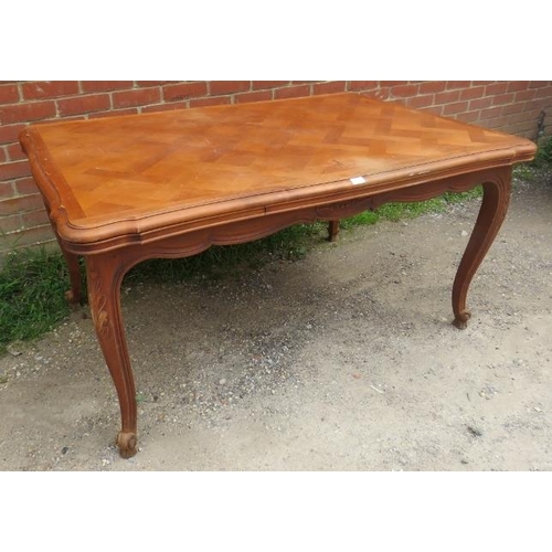 741 - A vintage French walnut draw-leaf extending dining table, the shaped top with parquetry inlay, on ac... 