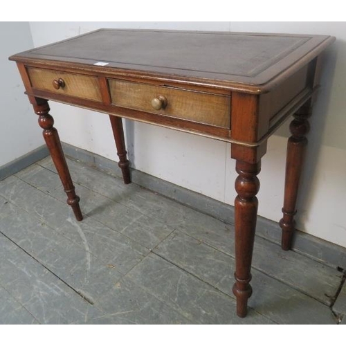 743 - A Victorian mahogany writing table, with inset brown leather surface, housing two cock-beaded short ... 