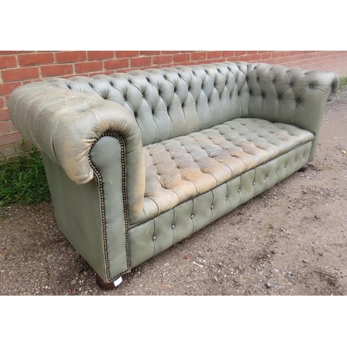 751 - A vintage three-seater Chesterfield sofa, upholstered in distressed grey leather with brass studs, o... 