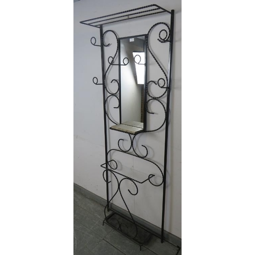 752 - A vintage French wrought iron hall stand painted black, featuring scrolled detail and six coat-hooks... 