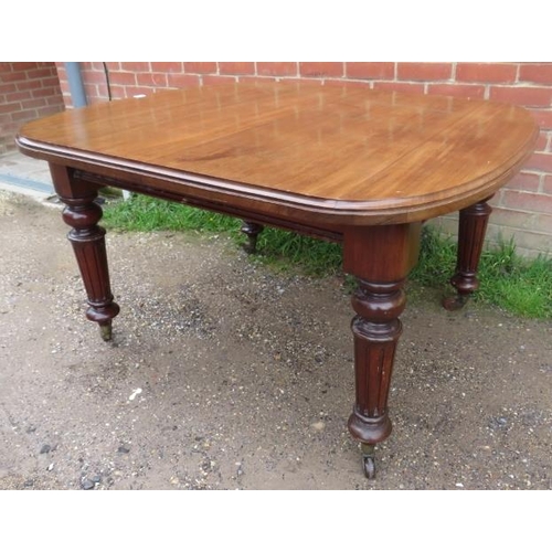 753 - A Victorian mahogany wind-out extending dining table with three small additional leaves, on tapering... 