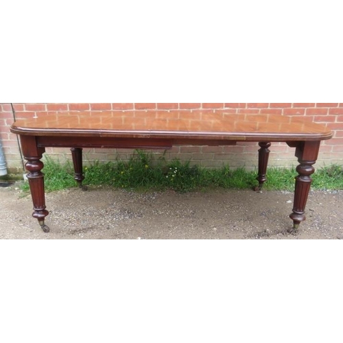 753 - A Victorian mahogany wind-out extending dining table with three small additional leaves, on tapering... 