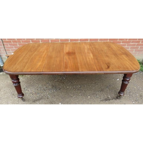 753 - A Victorian mahogany wind-out extending dining table with three small additional leaves, on tapering... 