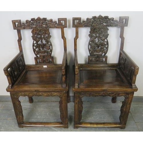 759 - A pair of early 20th century Chinese armchairs in the 19th century style, with ornately carved and p... 