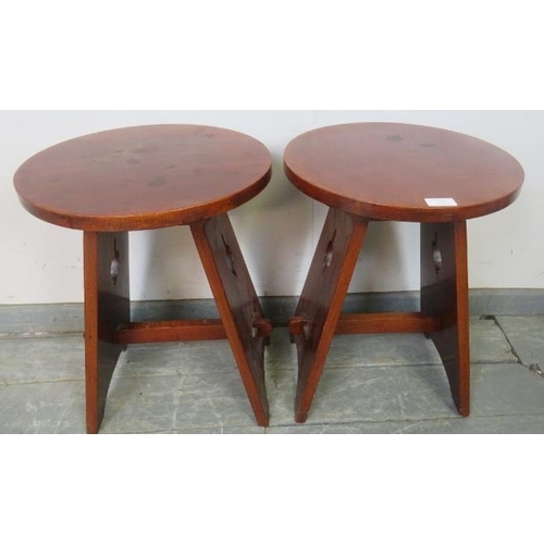 762 - A pair of Arts & Crafts circular mahogany side tables, on canted stile supports with pierced side de... 