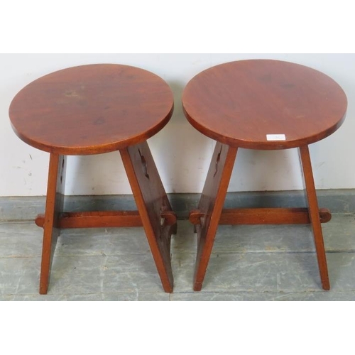 762 - A pair of Arts & Crafts circular mahogany side tables, on canted stile supports with pierced side de... 