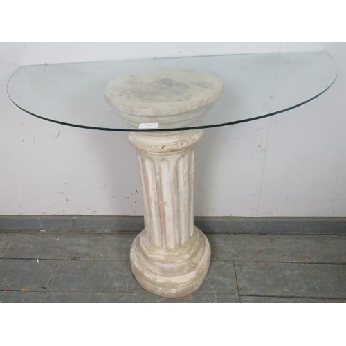 764 - A glass topped demi-lune console table, raised on a Corinthian style column base.
H72cm W100cm D51cm... 