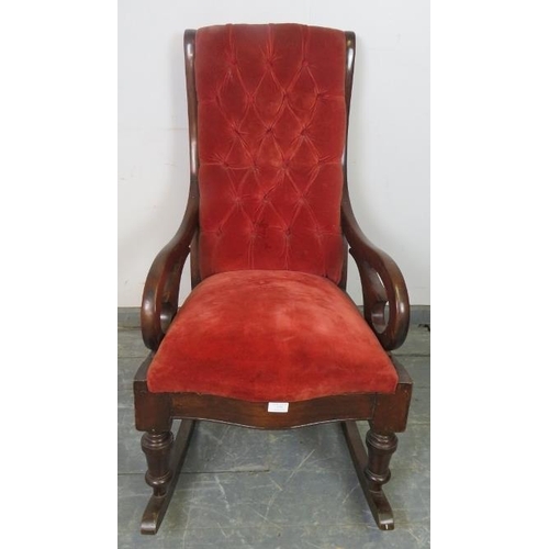 770 - A Victorian mahogany rocking chair with scrolled arms, upholstered in buttoned red velvet material, ... 