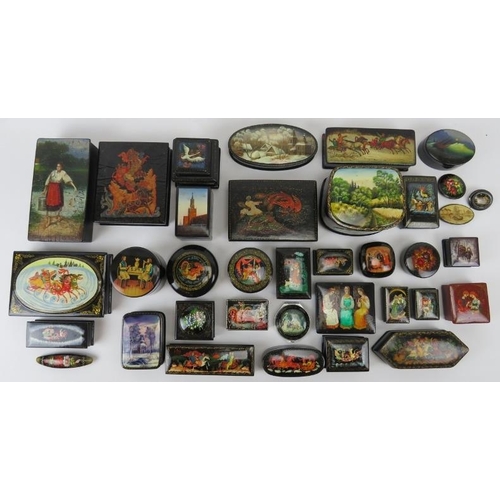 275 - Collection of thirty six Russian lacquer papier Mache boxes, hair slides, brooches, some signed. (36... 