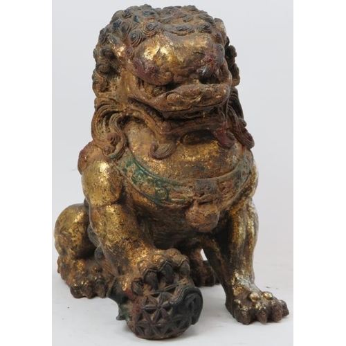 110 - A pair of Chinese silver and gold gilt and polychrome painted cast metal Buddhistic lions. (2 items)... 