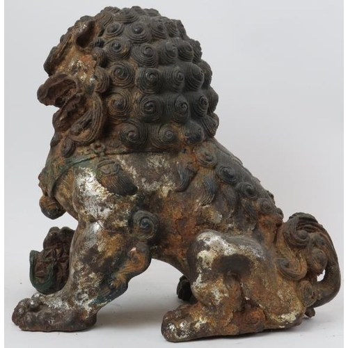 110 - A pair of Chinese silver and gold gilt and polychrome painted cast metal Buddhistic lions. (2 items)... 