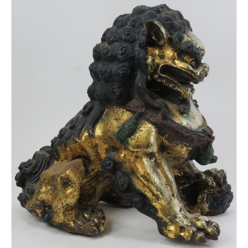 110 - A pair of Chinese silver and gold gilt and polychrome painted cast metal Buddhistic lions. (2 items)... 