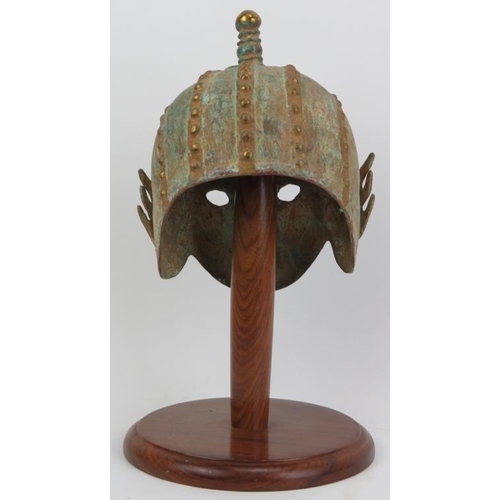 118 - A decorative Oriental bronze helmet, probably 20th century. Partially gilt with verdigris. 16.5 in (... 