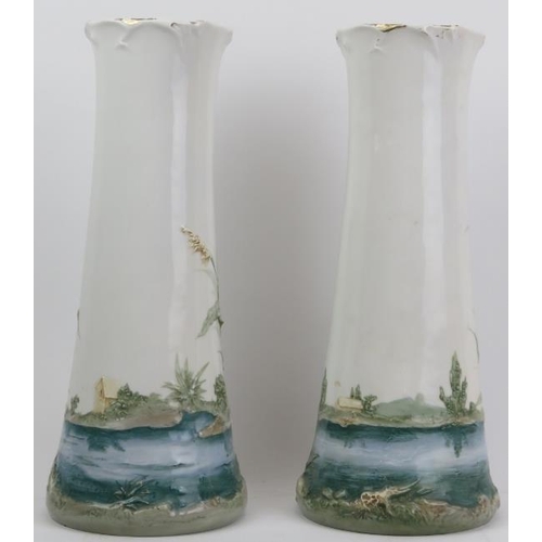 122 - A pair of European vases, late 19th/early 20th century. Both decorated in relief with riverside scen... 